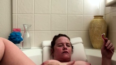 Attractive brunette teenager with big boobs fingering pussy